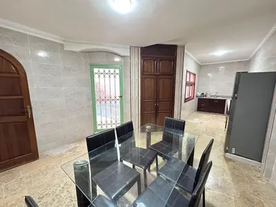 a dining room with a glass table and chairs at Élégante Villa 3 Chambres avec Jardin & Piscine Targa Afak Marrakech in Marrakech