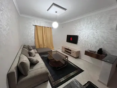 a living room with a couch and a tv at Y&J Stay - Modern and Comfort in Marrakech