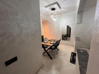 a dining room with a wooden table and chairs at Y&J Stay - Modern and Comfort in Marrakech