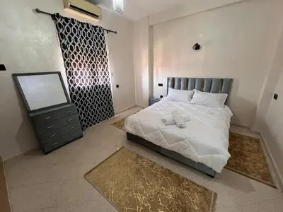 a bedroom with a bed and a dresser and a mirror at Y&J Stay - Modern and Comfort in Marrakech