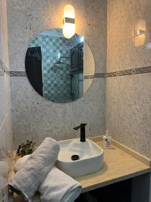 a bathroom with a sink and a mirror at Golden palm appart in Marrakech