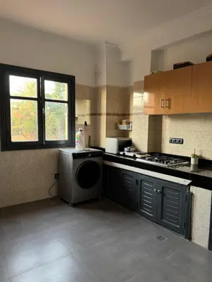 a kitchen with a washer and dryer in it at Golden palm appart in Marrakech