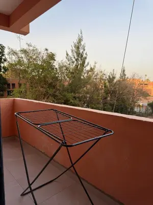 a metal table on a balcony with a view at Golden palm appart in Marrakech