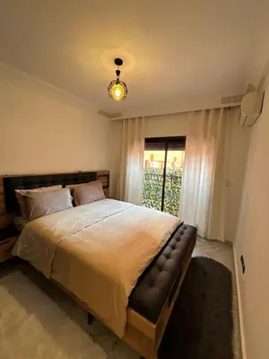 a bedroom with a large bed and a window at Appartement Gueliz Carré Eden 90m2 idéalement placé in Marrakech