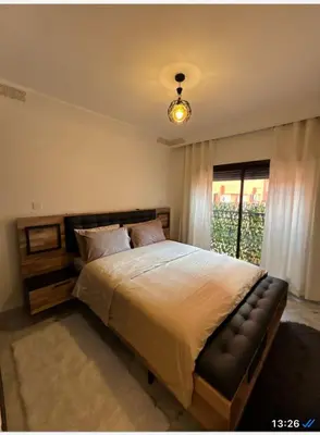 a bedroom with a large bed and a window at Appartement Gueliz Carré Eden 90m2 idéalement placé in Marrakech
