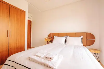 a bedroom with a white bed with two towels on it at Z-series Appartement unique et moderne in Marrakech
