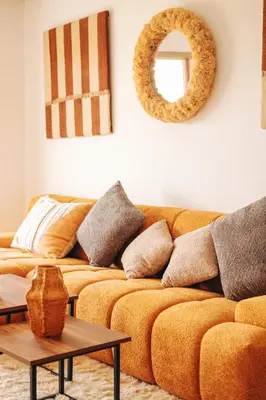 a living room with a couch and a mirror at Z-series Appartement unique et moderne in Marrakech