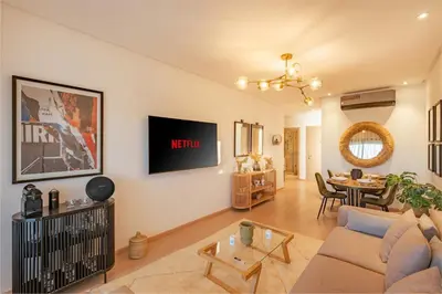a living room with a couch and a table at Z Series Cozy and Modern Apartment in Marrakech