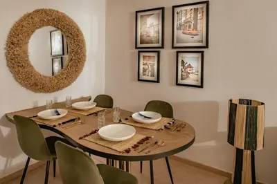a dining room with a table with chairs and a mirror at Z Series Cozy and Modern Apartment in Marrakech