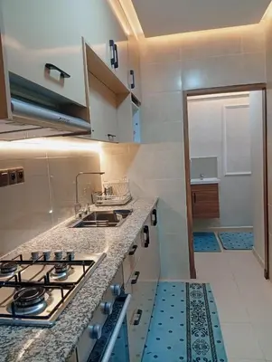 a kitchen with a stove and a counter top at Airport view apartment Marrakech in Marrakech
