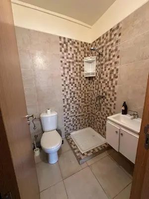 a bathroom with a toilet and a sink at Beautiful apartment with children's pool in Marrakech