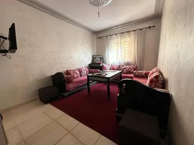 a living room with pink couches and a table at Beautiful apartment with children's pool in Marrakech