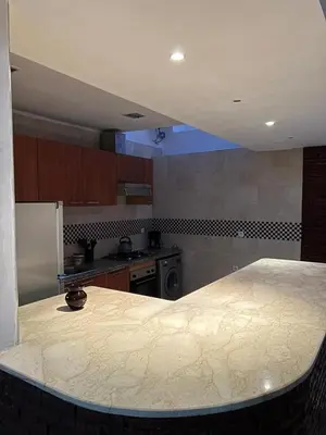 a kitchen with a large marble counter top at hébergement in Guéliz in Marrakech
