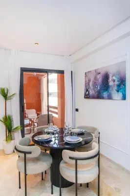a dining room with a table and chairs at Modern apartment-pool-secure Gueliz in Marrakech