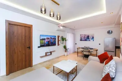 a living room with a white couch and a table at Modern apartment-pool-secure Gueliz in Marrakech
