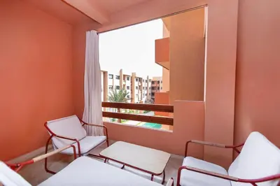 a room with chairs and a window with a view at Modern apartment-pool-secure Gueliz in Marrakech