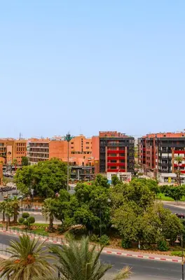 a city with buildings and trees and a street at Luxuriöse Wohnung im Herzen von Marrakesch Gueliz in Marrakech