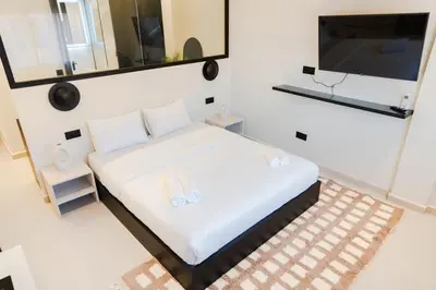 a bedroom with a bed and a flat screen tv at Studio Chic Coeur de Gueliz in Marrakech