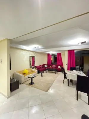 a living room with a couch and a table at Vue Fontaine appart in Marrakech