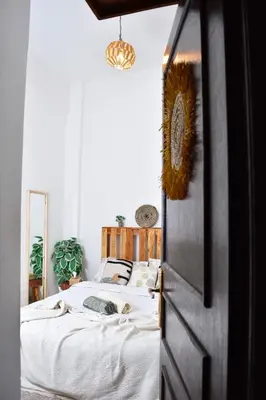 a bedroom with a bed with white sheets at Quiet apartment of traditional Moroccan in Marrakech