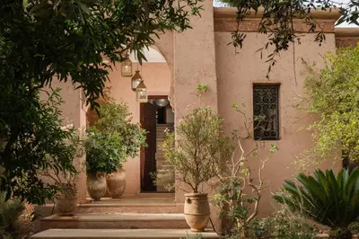 an entrance to a house with trees in front of it at Lankah - Authentic villa with private heated pool close to city center in Douar Caïd Layadi