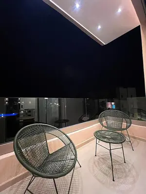 two chairs and a table in front of a window at Luxury Apartment & Atlas View in Marrakech