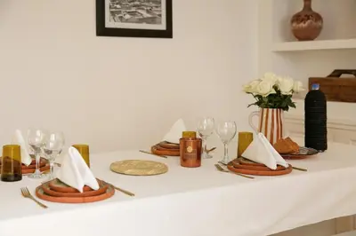 a table with plates and napkins and glasses on it at Riad Akwaba Charm and Comfort in Marrakech