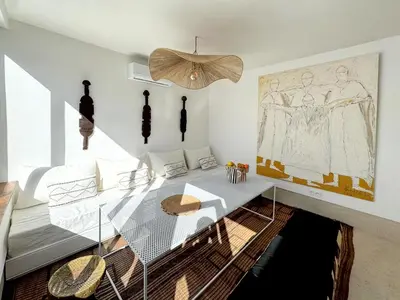 a dining room with a glass table and a chandelier at Riad Akwaba Charm and Comfort in Marrakech