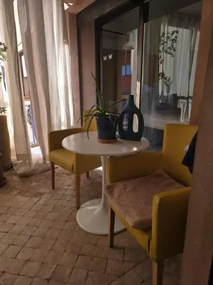a table and chairs with a plant on top of it at La Terrasse in Marrakech