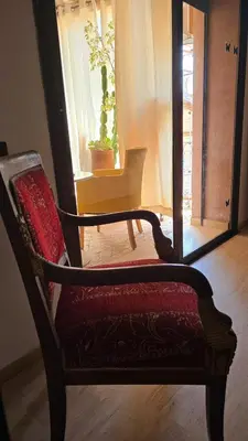 a chair sitting in a room with a window at La Terrasse in Marrakech