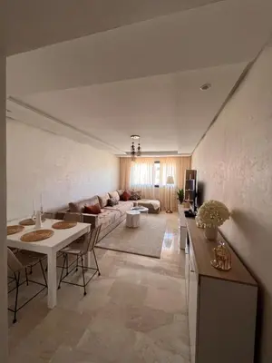 a living room with a couch and a table at GYM POOL Flat Marrakech Central City in Marrakech