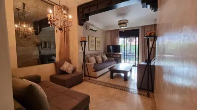 a living room with a couch and a table at Dar Saad Atlas golf in Marrakech