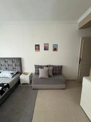 a living room with a bed and a couch at Albaraka building in Marrakech