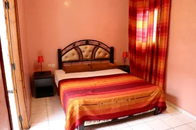 a bedroom with a bed in a room at Ryad OMS Marrakech in Marrakech