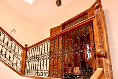 a wooden cabinet with wine bottles in it at Ryad OMS Marrakech in Marrakech