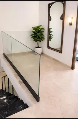 a glass staircase with a potted plant and a mirror at Duplex Moderne et Confort in Marrakech