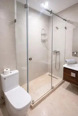 a bathroom with a shower and a toilet and a sink at Duplex Moderne et Confort in Marrakech