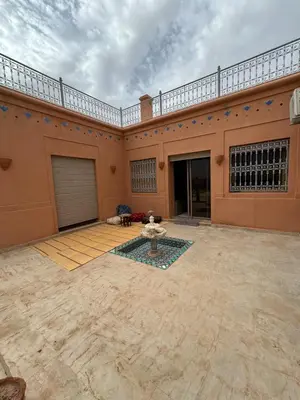 a large building with a courtyard with a fountain at Villa Benben 6 minutes du Grand Stade de Marrakech in Marrakech