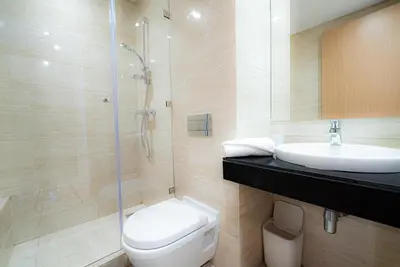 a bathroom with a toilet and a sink and a shower at M REVASION Appt 3 chambres , front de lac , piscine chauffée privée in Marrakech