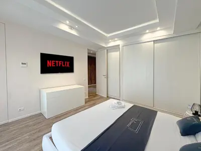 a bedroom with a bed and a tv on the wall at Villa Leonardo in Marrakech