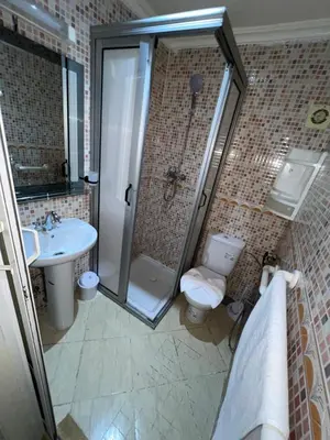 a bathroom with a shower and a toilet and a sink at votre parfait sejour in Marrakech