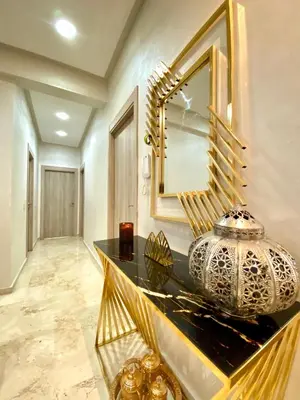 a room with a mirror and a vase on a counter at Lux appartement avec piscine in Marrakech
