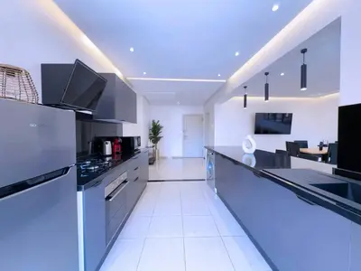a kitchen with black and white appliances in a room at Appart Confort et raffinement au cœur de Marrakech in Marrakech