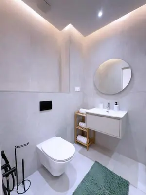 a bathroom with a toilet and a sink and a mirror at Appart Confort et raffinement au cœur de Marrakech in Marrakech