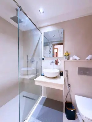 a bathroom with a sink and a glass shower at Charmant Appart , Confort avec balcon et piscine in Marrakech