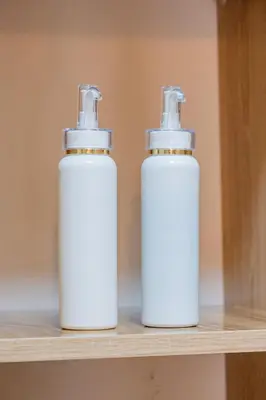 two white bottles ofodorizers sitting on a shelf at Central Marrakech Apart 2 Minutes from M Avenue with Pool & parking & Wifi in Marrakech