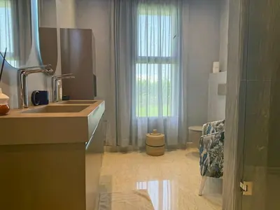 a white bathroom with a sink and a window at Luxury Villa Pool with Atlas View in Moussiha