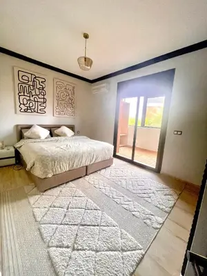 a bedroom with a bed and a sliding glass door at Superbe villa 3 chambres proche du centre-ville avec piscine privée in Marrakech