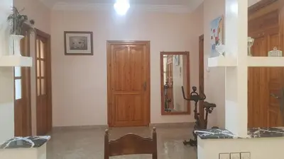 a room with a wooden door and a mirror at Home for peace & enjoyment in Marrakech