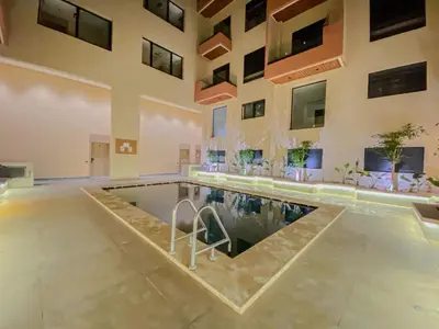 an indoor pool in a building with a swimming pool at Laube Hivernage in Marrakech